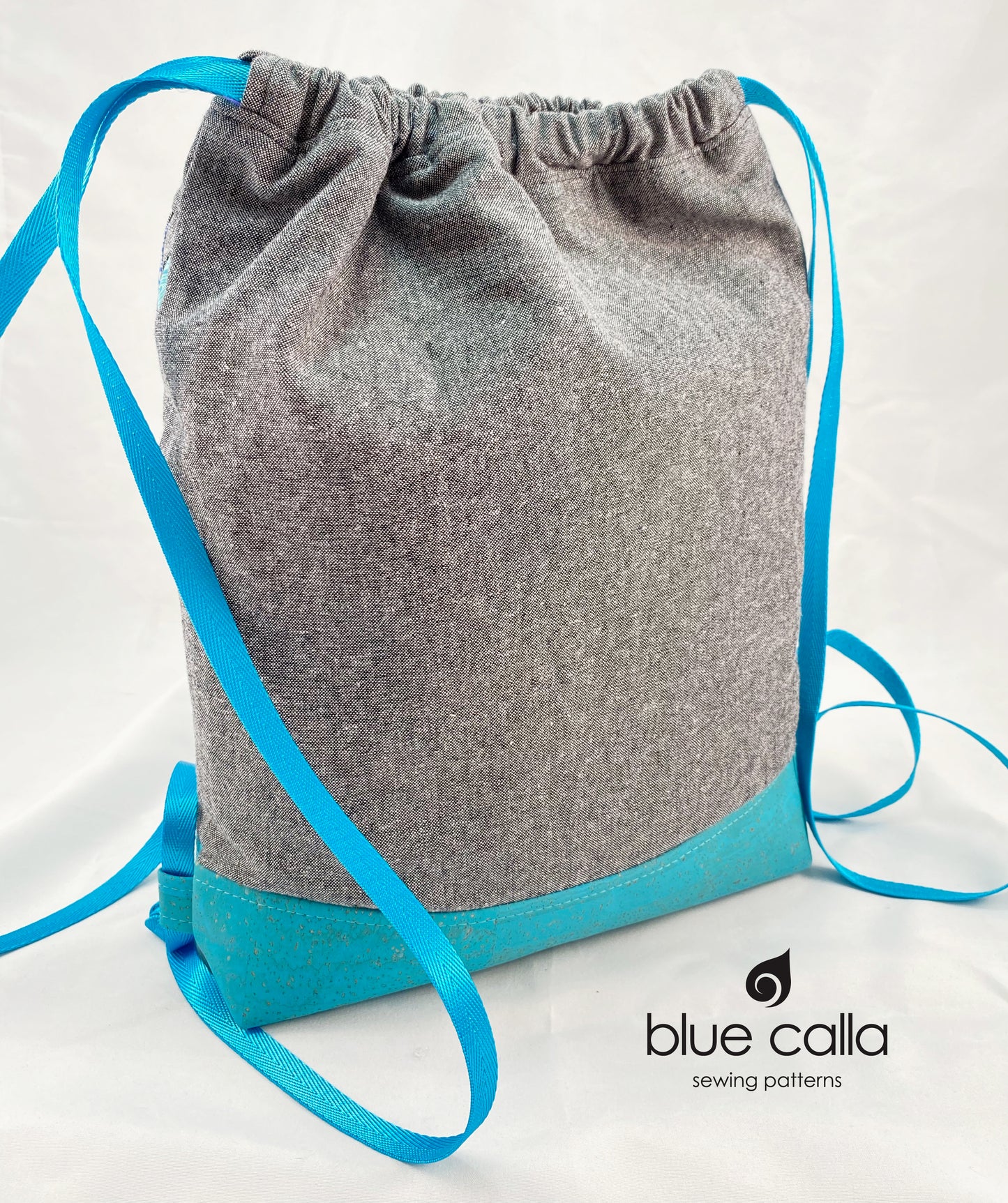 Begonia Backpack in Rainbow Flying Geese on Charcoal Essex with Aqua cork