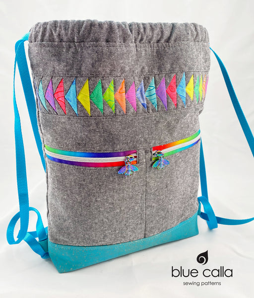 Begonia Backpack in Rainbow Flying Geese on Charcoal Essex with Aqua cork